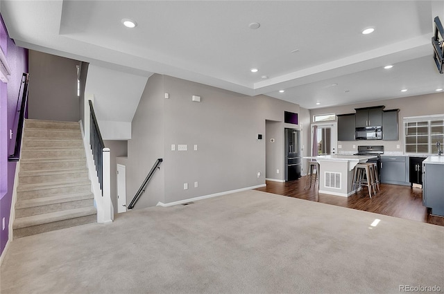 unfurnished living room featuring dark colored carpet