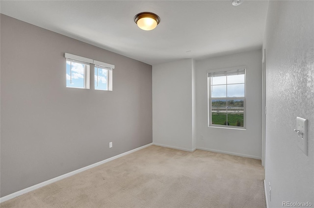 unfurnished room with light colored carpet