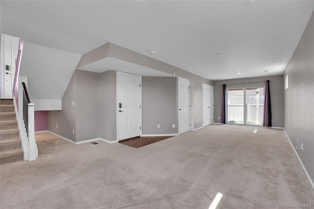 unfurnished living room with light colored carpet