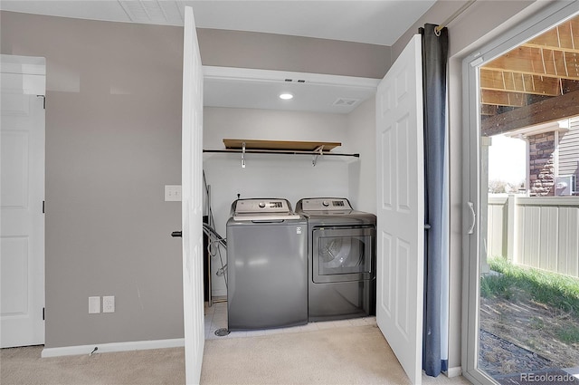 laundry area with light carpet and separate washer and dryer