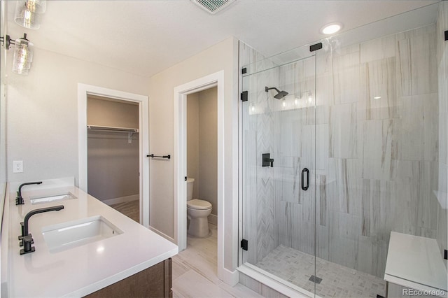 2076 S Holly St Unit 1, Denver, CO 80222 - full bathroom with a stall shower, double vanity, and a spacious closet