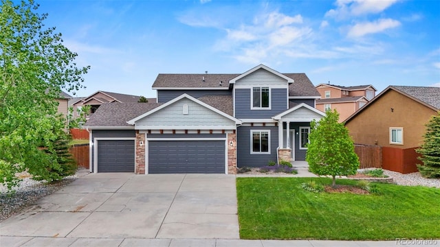 12532 Mount Belford Way, Peyton, CO 80831 - view of front of house with an attached garage, driveway, and stone siding