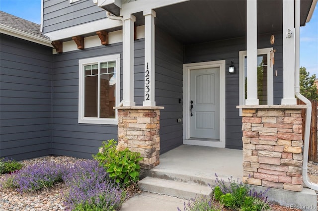 12532 Mount Belford Way, Peyton, CO 80831 - view of exterior entry with stone siding and a porch