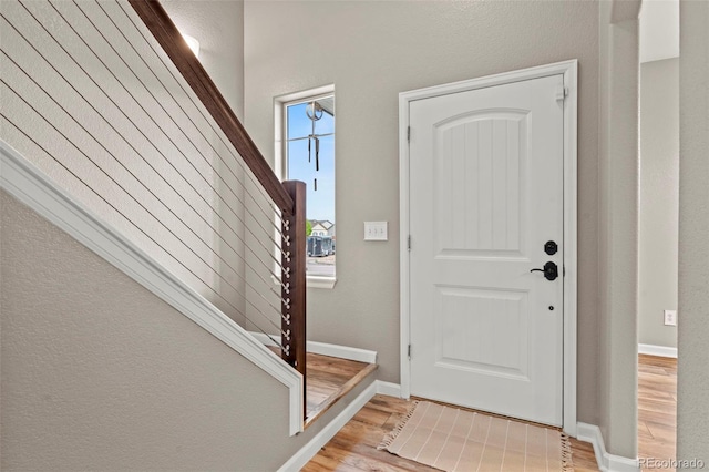 12532 Mount Belford Way, Peyton, CO 80831 - entryway with stairs, light wood finished floors, and baseboards