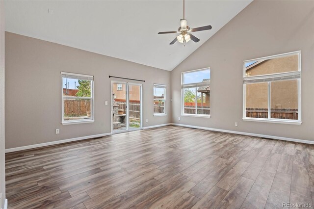 12532 Mount Belford Way, Peyton, CO 80831 - unfurnished room featuring high vaulted ceiling, wood finished floors, ceiling fan, healthy amount of natural light, and baseboards