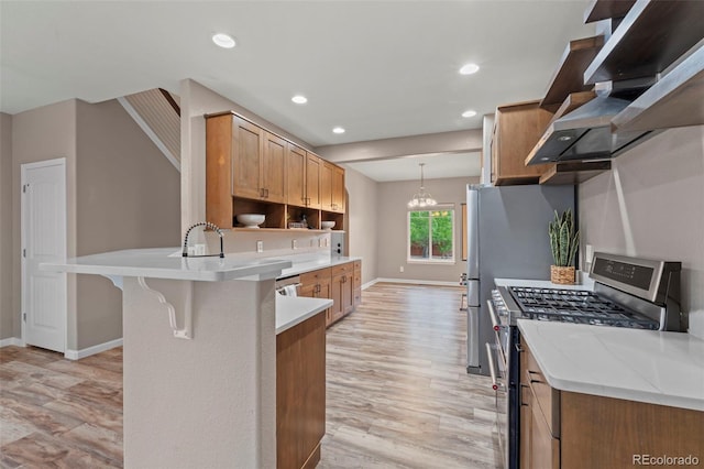12532 Mount Belford Way, Peyton, CO 80831 - kitchen featuring stainless steel range with gas cooktop, wall chimney range hood, baseboards, a peninsula, and recessed lighting