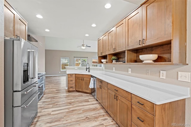 12532 Mount Belford Way, Peyton, CO 80831 - kitchen with appliances with stainless steel finishes, light wood-style flooring, a peninsula, a ceiling fan, and recessed lighting