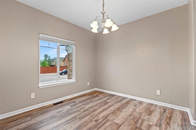 12532 Mount Belford Way, Peyton, CO 80831 - empty room featuring a chandelier, baseboards, and wood finished floors