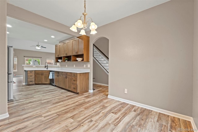 12532 Mount Belford Way, Peyton, CO 80831 - kitchen featuring baseboards, appliances with stainless steel finishes, light countertops, light wood finished floors, and pendant lighting