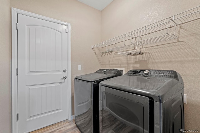 12532 Mount Belford Way, Peyton, CO 80831 - laundry room with washer and clothes dryer and light wood finished floors