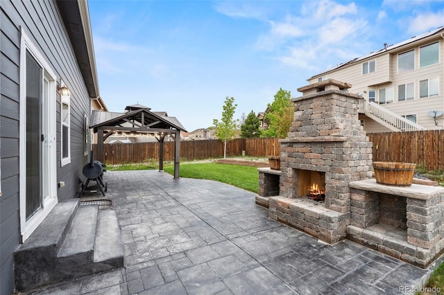 12532 Mount Belford Way, Peyton, CO 80831 - view of patio featuring an outdoor brick fireplace and a gazebo
