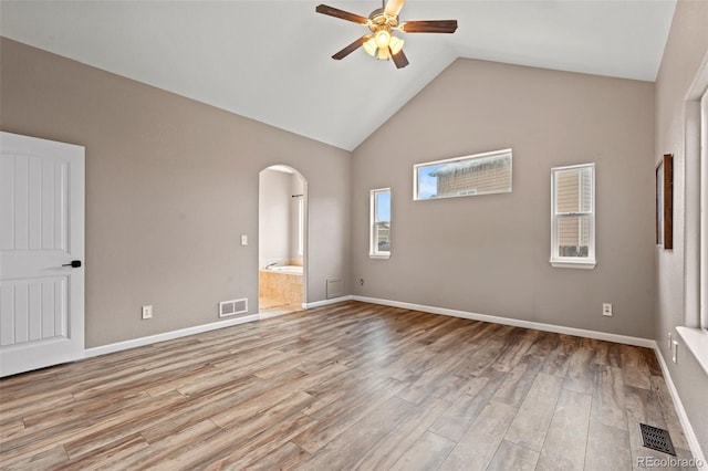 12532 Mount Belford Way, Peyton, CO 80831 - unfurnished room with a ceiling fan, arched walkways, light wood finished floors, high vaulted ceiling, and baseboards
