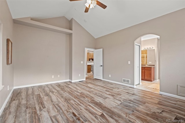 12532 Mount Belford Way, Peyton, CO 80831 - empty room featuring a ceiling fan, light wood-style floors, arched walkways, baseboards, and high vaulted ceiling