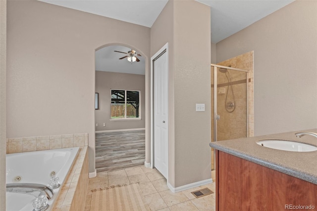12532 Mount Belford Way, Peyton, CO 80831 - bathroom featuring a tub with jets, a stall shower, tile patterned flooring, vanity, and ceiling fan