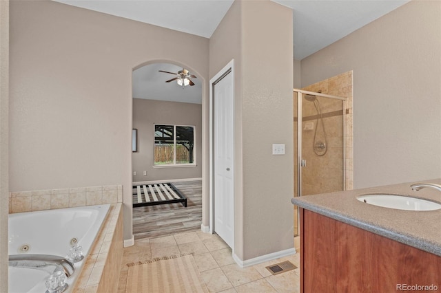 12532 Mount Belford Way, Peyton, CO 80831 - bathroom featuring a whirlpool tub, a stall shower, tile patterned floors, vanity, and a ceiling fan