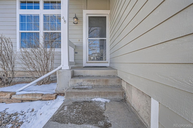 view of snow covered property entrance