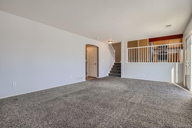 spare room with carpet and a textured ceiling