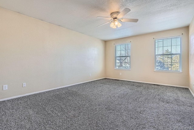 unfurnished room featuring dark colored carpet, ceiling fan, and a textured ceiling