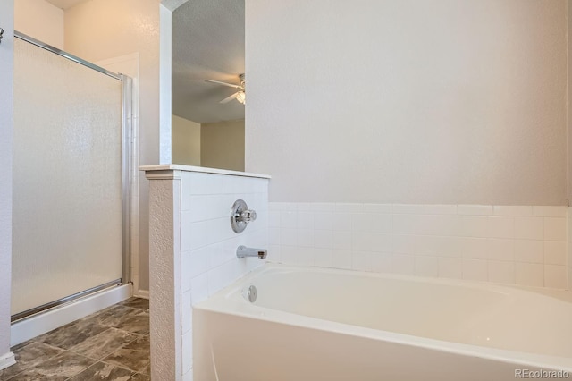 bathroom with a textured ceiling, independent shower and bath, and ceiling fan