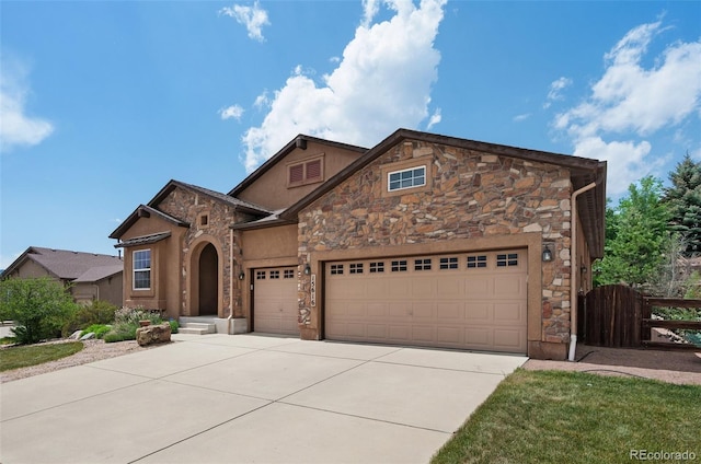 15616 Soo Line Way, Monument, CO 80132 - traditional-style home featuring stone siding, concrete driveway, an attached garage, and stucco siding