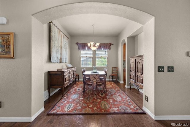 15616 Soo Line Way, Monument, CO 80132 - dining space featuring arched walkways, a chandelier, wood finished floors, and baseboards