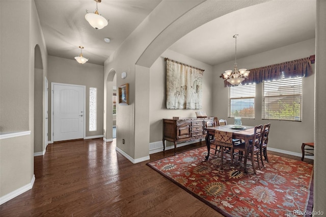 15616 Soo Line Way, Monument, CO 80132 - dining space with arched walkways, wood finished floors, a chandelier, and baseboards