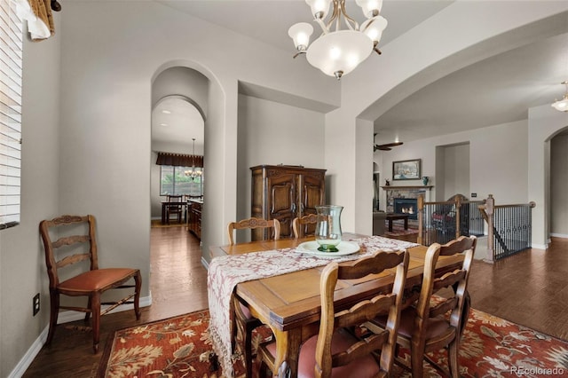 15616 Soo Line Way, Monument, CO 80132 - dining space featuring arched walkways, a chandelier, and wood finished floors