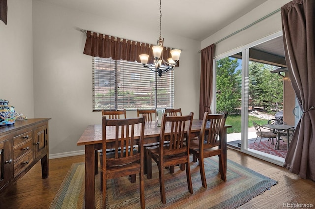 15616 Soo Line Way, Monument, CO 80132 - dining room featuring a chandelier, wood finished floors, and baseboards