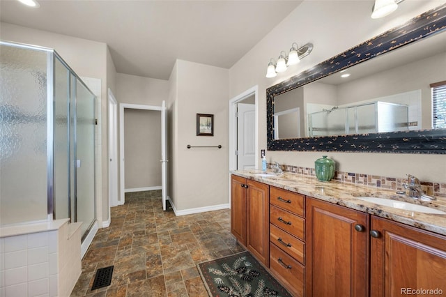15616 Soo Line Way, Monument, CO 80132 - full bath with stone finish floors, a shower stall, double vanity, and baseboards