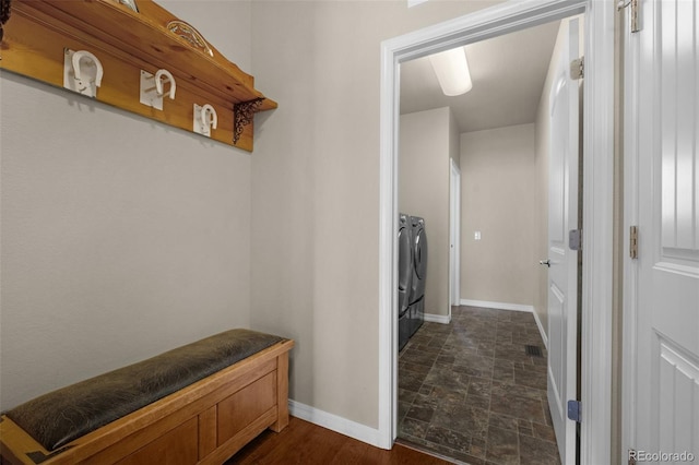 15616 Soo Line Way, Monument, CO 80132 - laundry area with washing machine and dryer, baseboards, and dark stone finish floors