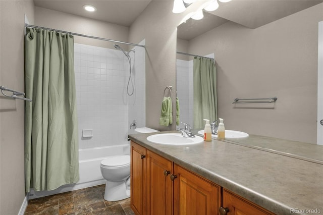 15616 Soo Line Way, Monument, CO 80132 - bathroom with vanity, shower / bath combo, toilet, stone finish floors, and baseboards