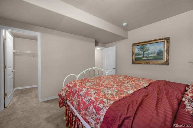 15616 Soo Line Way, Monument, CO 80132 - bedroom with light colored carpet, a spacious closet, and baseboards