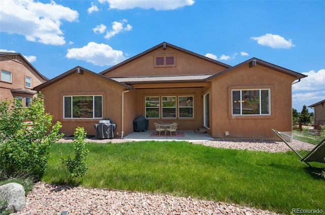 15616 Soo Line Way, Monument, CO 80132 - back of property featuring a patio, a yard, and stucco siding