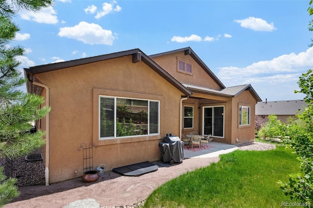15616 Soo Line Way, Monument, CO 80132 - rear view of house with a patio area, stucco siding, and a lawn