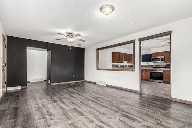 710 4th St, Bennett, CO 80102 - unfurnished living room featuring ceiling fan, dark wood finished floors, a textured ceiling, and baseboards