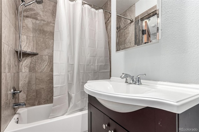 710 4th St, Bennett, CO 80102 - bathroom featuring shower / bathtub combination with curtain, a textured wall, and vanity