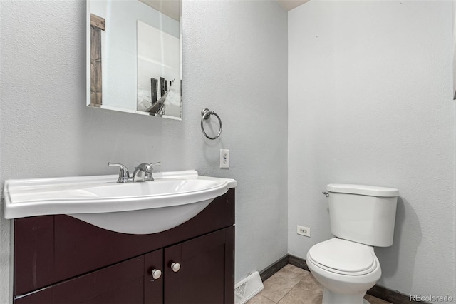 710 4th St, Bennett, CO 80102 - bathroom featuring vanity, toilet, tile patterned floors, and baseboards