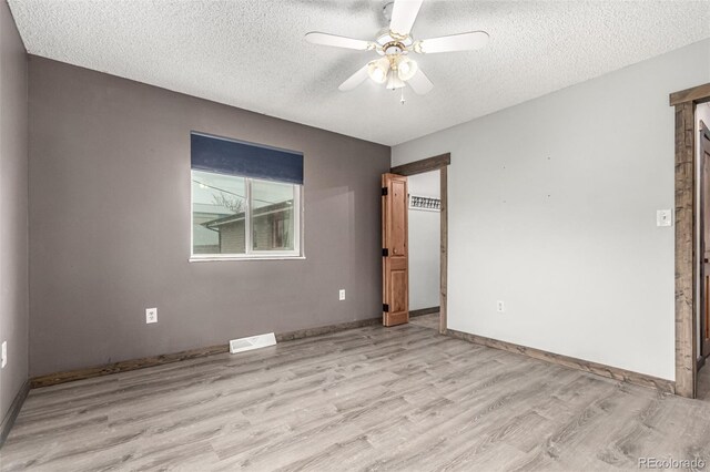 710 4th St, Bennett, CO 80102 - unfurnished room featuring light wood-type flooring, a textured ceiling, ceiling fan, and baseboards