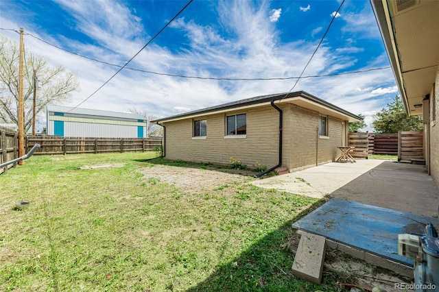 710 4th St, Bennett, CO 80102 - view of property exterior featuring a patio and brick siding