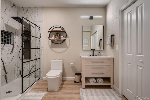 bathroom with vanity, hardwood / wood-style flooring, toilet, and walk in shower