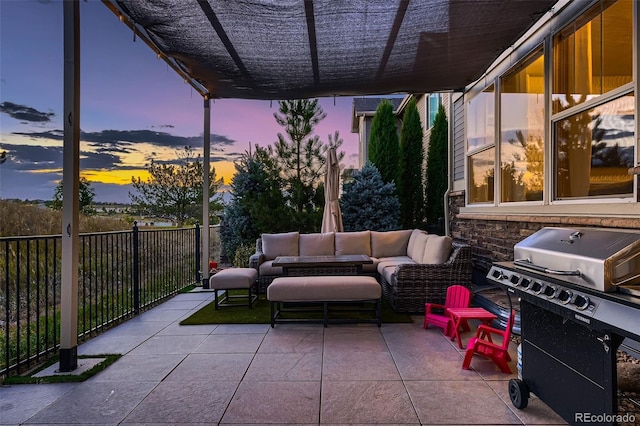 patio terrace at dusk with grilling area and an outdoor hangout area