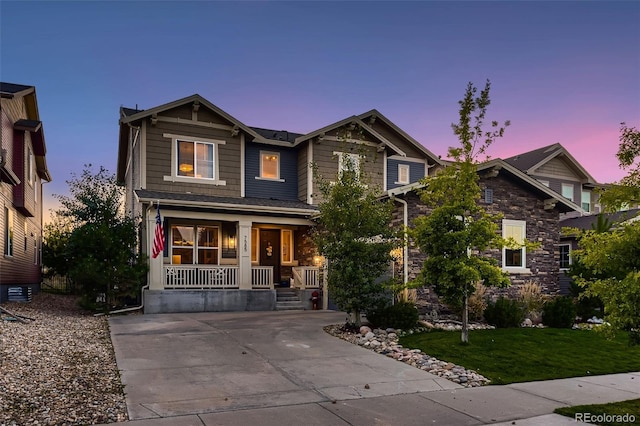 craftsman-style house featuring a lawn and a porch