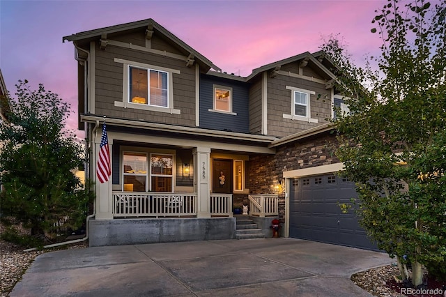 craftsman-style house featuring a porch and a garage