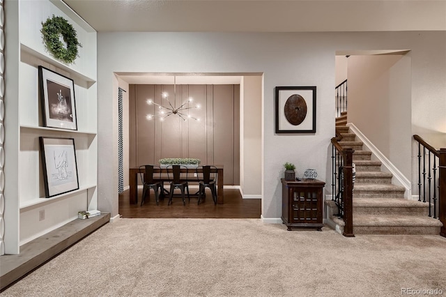 interior space featuring dark carpet and a notable chandelier