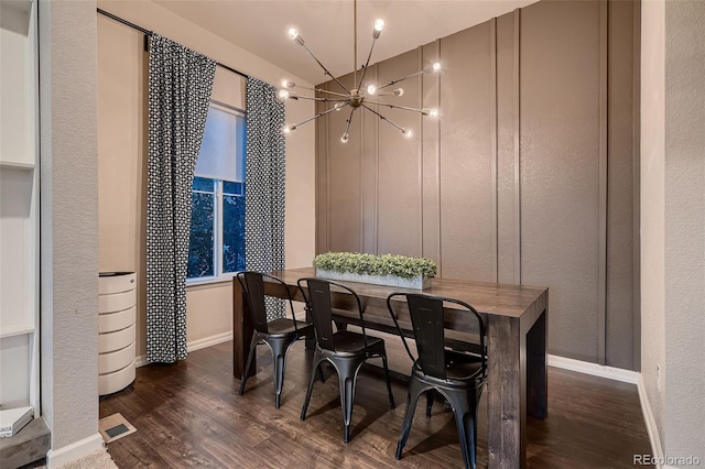 dining space with a notable chandelier and dark hardwood / wood-style floors