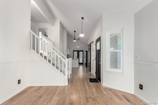 772 Ivywood Ct, Highlands Ranch, CO 80126 - foyer with a barn door, stairs, wood finished floors, lofted ceiling, and ceiling fan