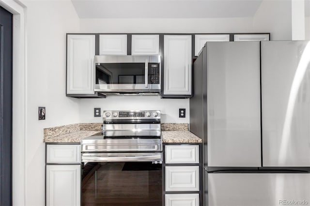 772 Ivywood Ct, Highlands Ranch, CO 80126 - kitchen featuring stainless steel appliances, white cabinetry, and light stone counters