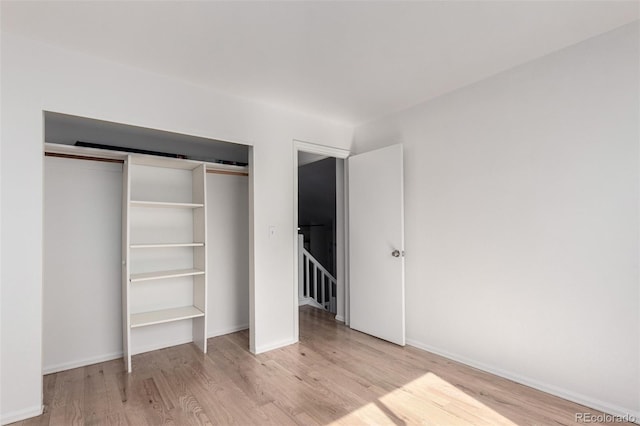 772 Ivywood Ct, Highlands Ranch, CO 80126 - unfurnished bedroom featuring wood finished floors, a closet, and baseboards
