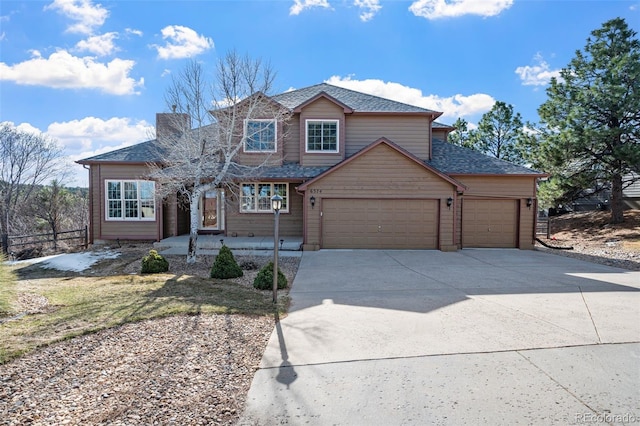 view of front of property with driveway, a shingled roof, and a garage