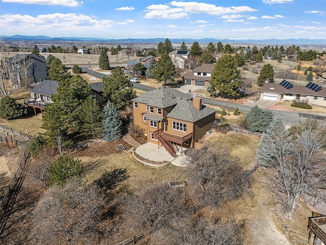 birds eye view of property with a mountain view and a residential view